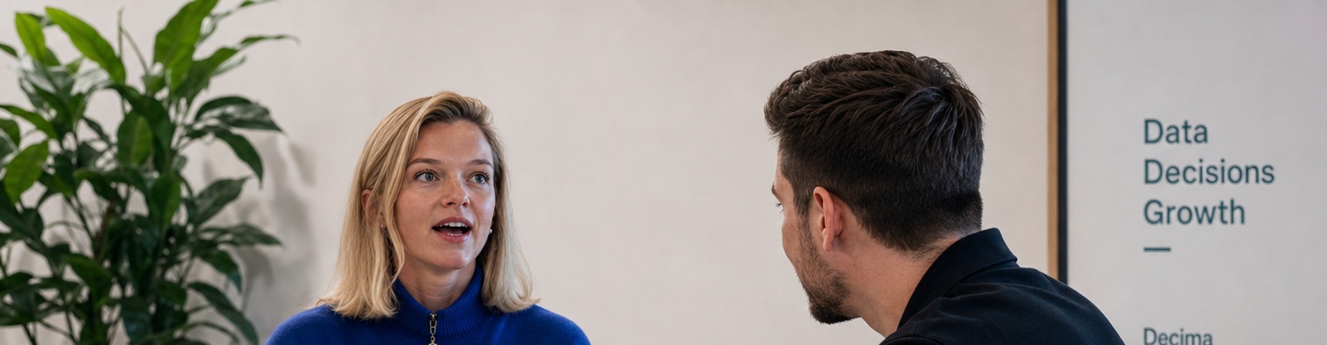 Two colleagues discussing Decisive Marketing decisions across a table